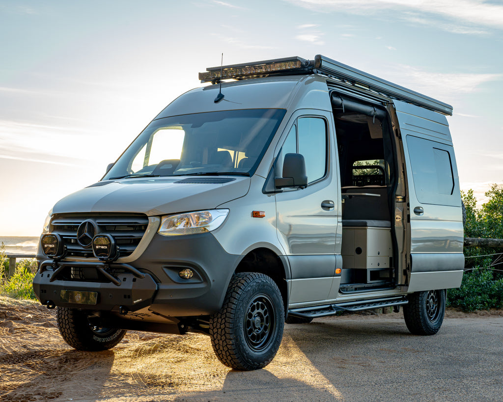 Burley Van Co Alta MWB Sprinter 4x4 campervan front three-quarter view at sunrise