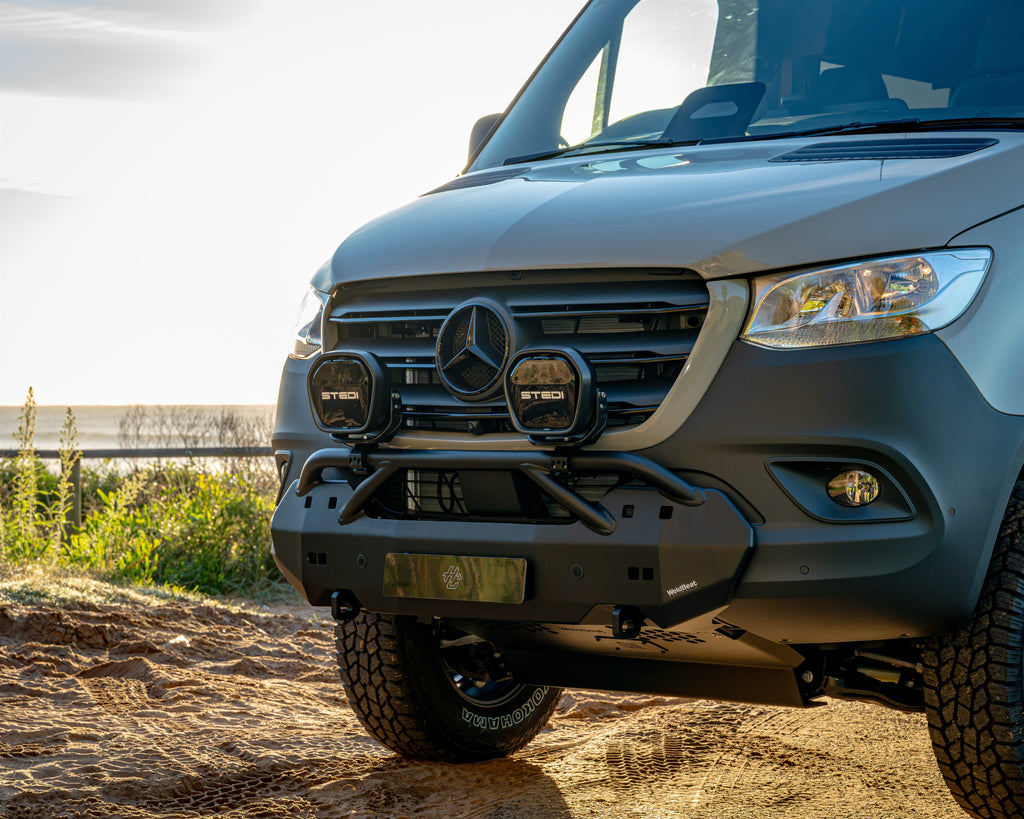 Burley Van Co Alta front bumper detail with STEDI driving lights and Mercedes-Benz grille